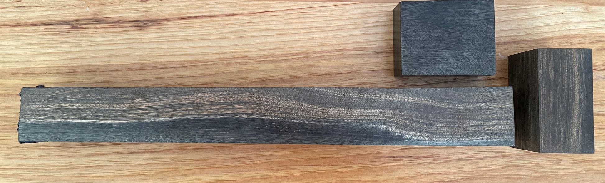 3 blocks of dark, richly colored wood