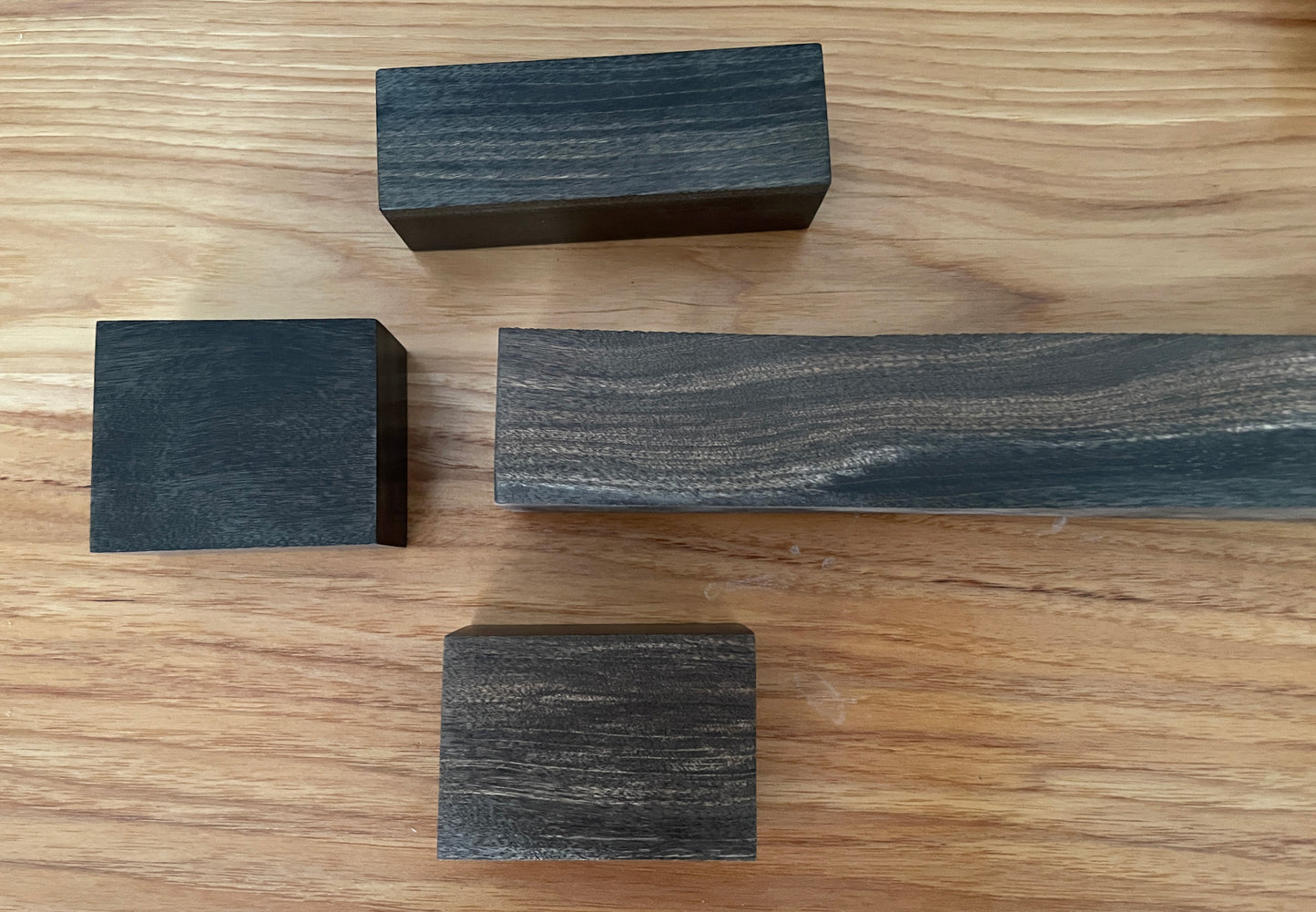 4 blocks of dark tropical looking wood